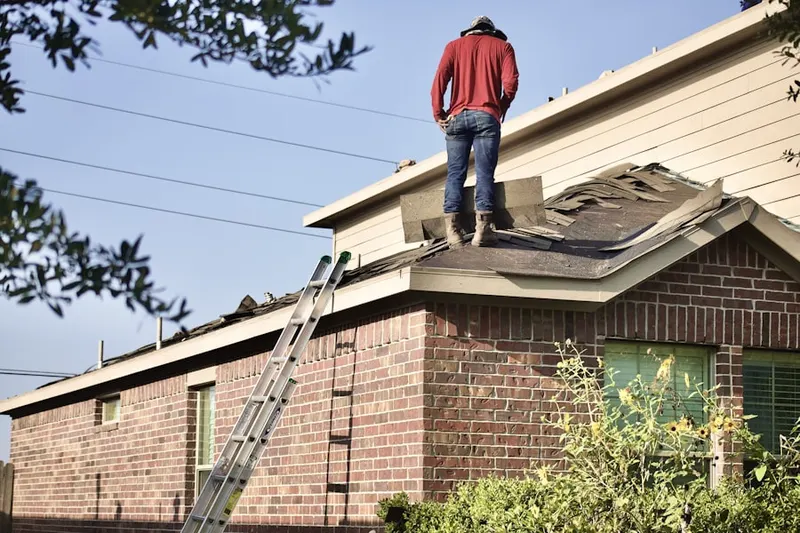 Professional roofer working on a residential roof in Penn View